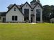 Beautiful two-story home with a painted brick facade, modern windows, a clean lawn, and tidy landscaping at 3735 Tamiami Trl, Cumming, GA 30041