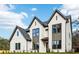 Beautiful two-story home featuring a painted brick facade, multiple gables, and modern windows at 3735 Tamiami Trl, Cumming, GA 30041