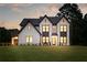 Beautiful, new construction two-story home with white brick, black trim and a large yard at 3735 Tamiami Trl, Cumming, GA 30041
