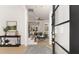 Inviting foyer with an open floor plan, staircase, artwork, and a view into the beautifully decorated living room at 3735 Tamiami Trl, Cumming, GA 30041