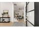 Inviting foyer featuring staircase, stylish console table, and views into the living area at 3735 Tamiami Trl, Cumming, GA 30041