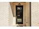 Stylish front door with glass panes and a brick surround, complete with matte black hardware at 3735 Tamiami Trl, Cumming, GA 30041
