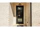 Close-up of a black front door with glass panels, a transom window, and a brick exterior at 3735 Tamiami Trl, Cumming, GA 30041