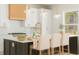 Bright kitchen with modern lighting, an island with bar stools, and white cabinetry at 3735 Tamiami Trl, Cumming, GA 30041
