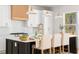 Bright, open kitchen with a large island, bar seating, custom range hood, and white cabinets at 3735 Tamiami Trl, Cumming, GA 30041