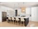 A modern, spacious kitchen with a large island, pendant lighting, and stainless steel appliances at 3735 Tamiami Trl, Cumming, GA 30041