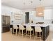 Bright, modern kitchen features a large island with seating and stainless steel appliances at 3735 Tamiami Trl, Cumming, GA 30041