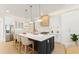Modern kitchen with white cabinets, stainless steel appliances, and a large island with seating at 3735 Tamiami Trl, Cumming, GA 30041