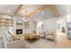 Open living space with wood-look flooring, fireplace, decorative shelves, and a modern ceiling fan at 3735 Tamiami Trl, Cumming, GA 30041