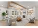 Bright living room with wooden beams, fireplace, built-in shelves, and large windows at 3735 Tamiami Trl, Cumming, GA 30041