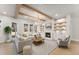 Bright living room featuring recessed lighting, wood beams, fireplace, and built-in shelving at 3735 Tamiami Trl, Cumming, GA 30041