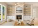 Cozy living room featuring a fireplace, built-in shelving, and neutral decor at 3735 Tamiami Trl, Cumming, GA 30041