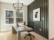 A well-lit office featuring paneled wall, modern chandelier, and views of the surrounding landscape at 3735 Tamiami Trl, Cumming, GA 30041