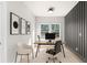 Home office with natural light, a modern desk and chair, and artistic decor at 3735 Tamiami Trl, Cumming, GA 30041