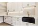 Walk-in pantry features a sink, white cabinets, drawers, and open shelves for organized storage at 3735 Tamiami Trl, Cumming, GA 30041