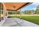 Covered patio features a ceiling fan, ample sunlight, and views of the beautifully landscaped yard at 3735 Tamiami Trl, Cumming, GA 30041