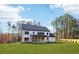 Back exterior of the home showcasing the well-maintained lawn and covered patio at 3735 Tamiami Trl, Cumming, GA 30041