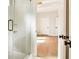 Shower with glass enclosure featuring a partially opened doorway to another room at 3735 Tamiami Trl, Cumming, GA 30041