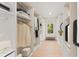 Organized walk-in closet with custom shelving, drawers, and a window that allows for natural light at 3735 Tamiami Trl, Cumming, GA 30041