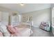 Bedroom featuring a crib, soft carpet, natural light, and neutral colors at 6160 Oriole Ln, Cumming, GA 30028