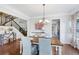 Elegant dining room with a modern chandelier and hardwood floors at 6160 Oriole Ln, Cumming, GA 30028