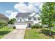 Charming two-story home with a well-manicured front yard, lovely lawn, and two car garage at 6160 Oriole Ln, Cumming, GA 30028