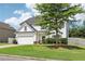 Lovely two-story home with green lawn, attached garage, and beautiful architectural details at 6160 Oriole Ln, Cumming, GA 30028