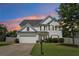 Charming two-story home featuring a well-manicured lawn, a two-car garage and classic architecture at 6160 Oriole Ln, Cumming, GA 30028