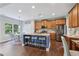 Spacious kitchen boasts wood cabinets, a large island, and stainless steel appliances at 6160 Oriole Ln, Cumming, GA 30028