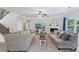 Bright living room with plush carpet, crown molding, and expansive windows at 6160 Oriole Ln, Cumming, GA 30028