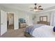 Main bedroom with a ceiling fan, carpet, adjoining bathroom, and natural light at 6160 Oriole Ln, Cumming, GA 30028