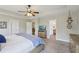 Main bedroom with a ceiling fan, carpet, adjoining bathroom, and natural light at 6160 Oriole Ln, Cumming, GA 30028
