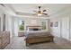 Main bedroom featuring a tray ceiling, carpet, large windows, and natural light at 6160 Oriole Ln, Cumming, GA 30028