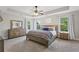 Main bedroom showcasing a tray ceiling, carpet, large windows, and natural light at 6160 Oriole Ln, Cumming, GA 30028
