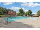 Community pool with lounge chairs and umbrellas on a sunny day at 6160 Oriole Ln, Cumming, GA 30028