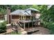 Back exterior featuring a spacious deck perfect for outdoor entertaining and a lush backyard at 6960 Hunters Branch Dr, Atlanta, GA 30328