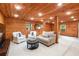 Cozy finished basement with wood paneling and plush seating area at 6960 Hunters Branch Dr, Atlanta, GA 30328