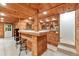 Basement bar with wooden construction, tile countertops, and room for stools at 6960 Hunters Branch Dr, Atlanta, GA 30328