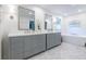 Bright bathroom featuring double vanity, white countertops, and luxurious soaking tub at 6960 Hunters Branch Dr, Atlanta, GA 30328
