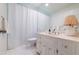 Neat bathroom featuring white vanity, toilet, and shower with white shower curtain at 6960 Hunters Branch Dr, Atlanta, GA 30328