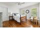 Bright bedroom with hardwood floors, ceiling fan, and abundant natural light at 6960 Hunters Branch Dr, Atlanta, GA 30328