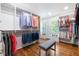 Well-organized walk-in closet with ample storage and bench seating at 6960 Hunters Branch Dr, Atlanta, GA 30328