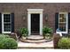 Front door entrance with updated features including black shutters and stone steps at 6960 Hunters Branch Dr, Atlanta, GA 30328
