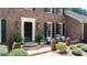 An exterior of the front entrance featuring a brick facade and decorative plants at 6960 Hunters Branch Dr, Atlanta, GA 30328