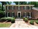Charming brick home featuring a well-manicured lawn and a welcoming front entrance and stone walkway at 6960 Hunters Branch Dr, Atlanta, GA 30328
