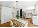 Eat-in kitchen features wood floors, white cabinets, stainless steel appliances and attached dining area at 6960 Hunters Branch Dr, Atlanta, GA 30328