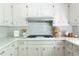 Close-up of a well-lit kitchen with white subway tiles and countertops at 6960 Hunters Branch Dr, Atlanta, GA 30328