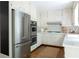 Bright kitchen featuring white cabinets, stainless steel appliances, and hardwood flooring at 6960 Hunters Branch Dr, Atlanta, GA 30328