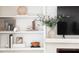 Built-in shelves in living room, featuring decorative items, books and a large television at 6960 Hunters Branch Dr, Atlanta, GA 30328