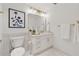 Elegant bathroom with marble countertops, white cabinetry, and gold fixtures at 75 14Th Ne St # 3820, Atlanta, GA 30309
